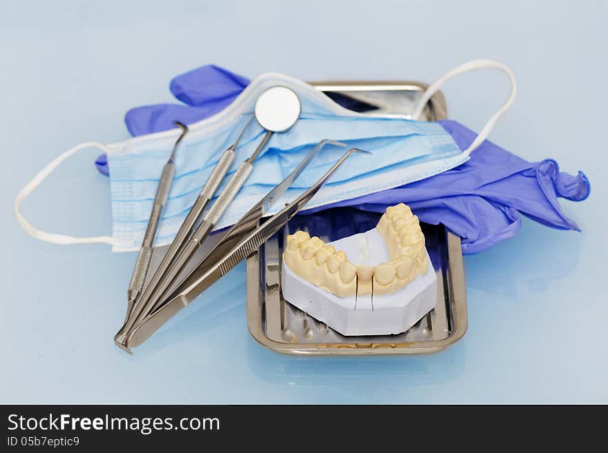 Dental instruments with gloves and mask and model