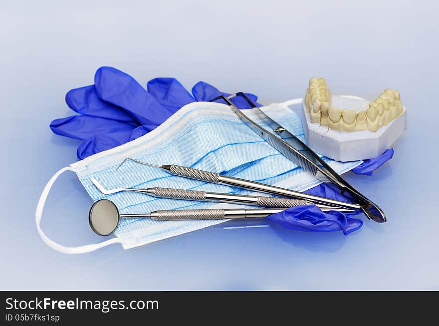 Dental instruments with gloves and mask and model