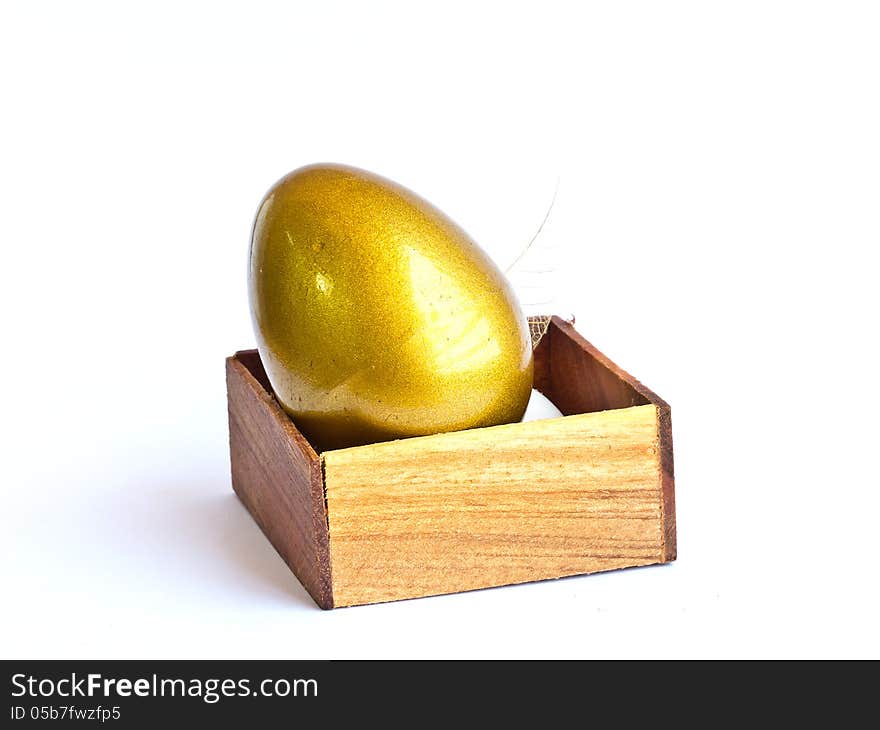 The golden Easter egg in the wooden box