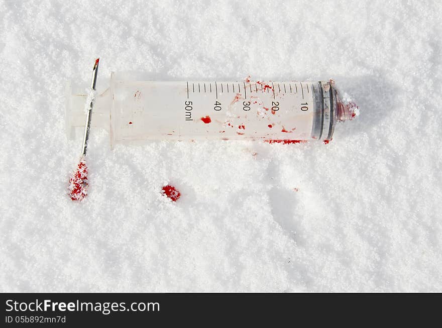 Bloody used syringe