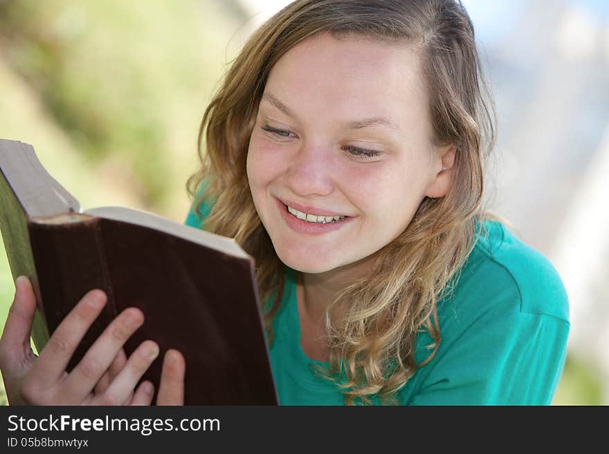 Portrait of a girl reading a book