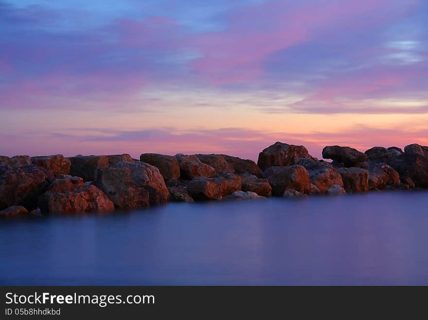 Stones in misty water at sunset