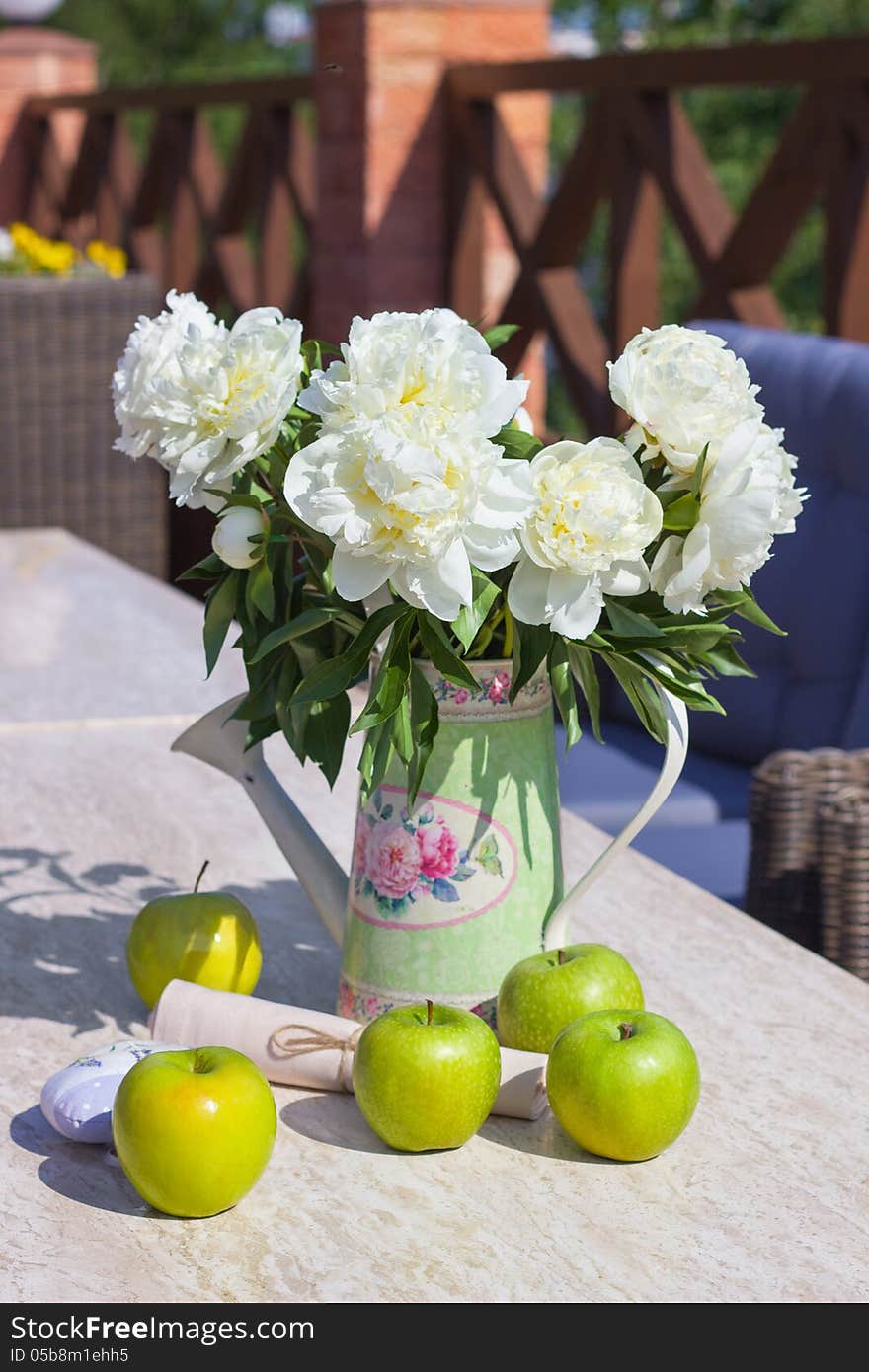 Ripe Green Apples And A Vase Of Peonies On A Marbl