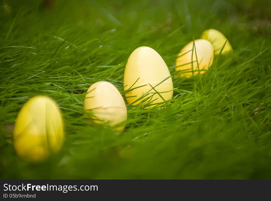 Easter eggs in grass background randomly scattered