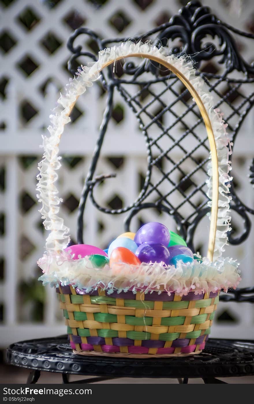 Easter eggs basket on chair with lattice background