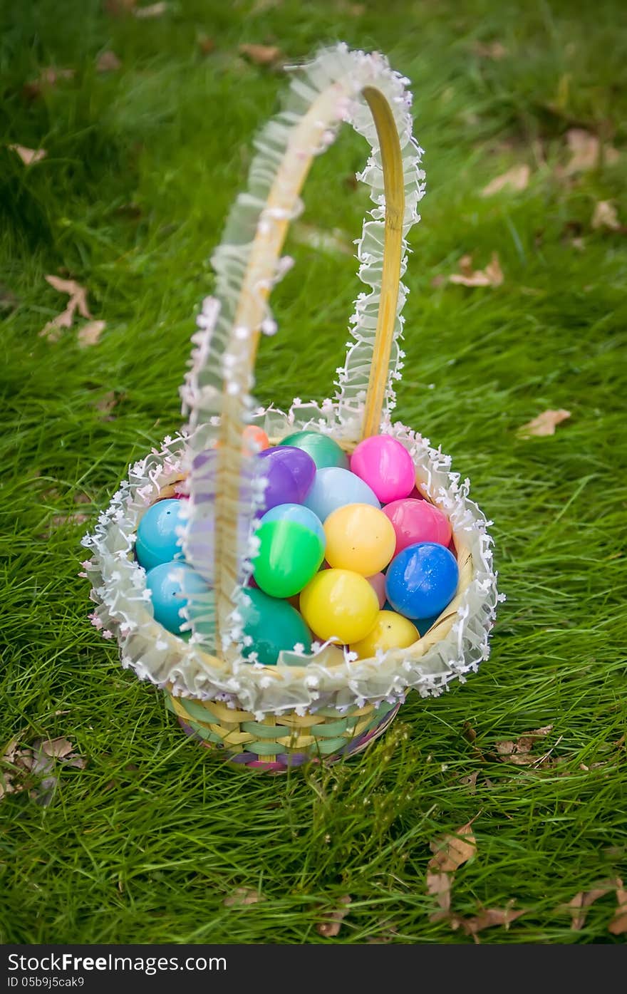 Easter eggs basket on grass background