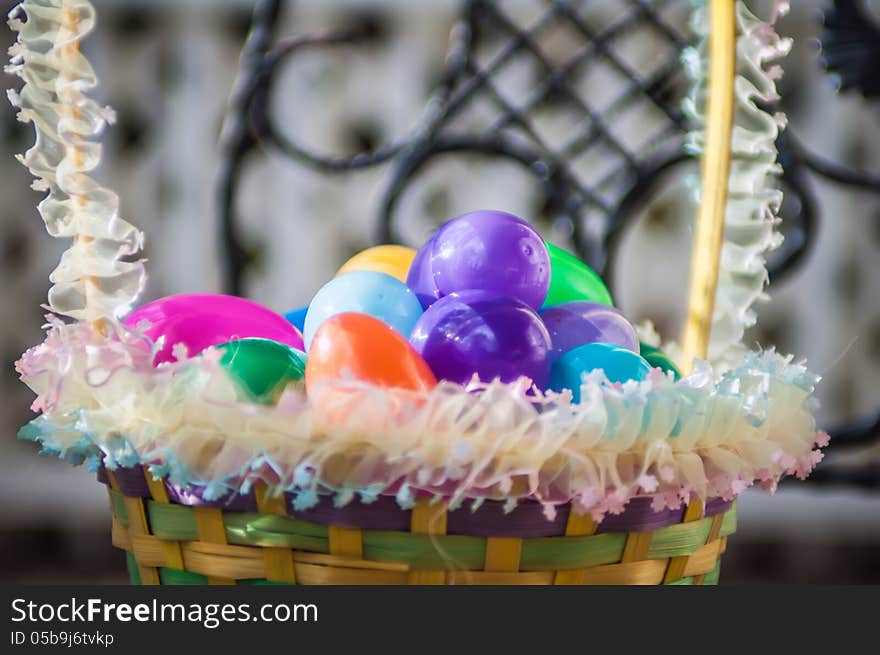 Easter eggs basket on chair with lattice background