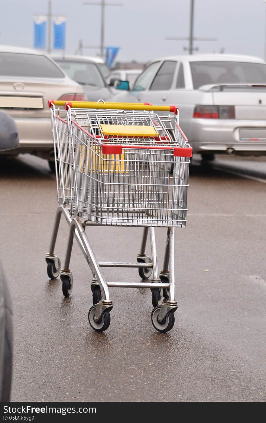 Shopping carts in the parking lot of vehicles. Shopping carts in the parking lot of vehicles