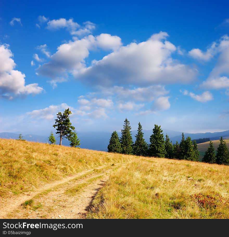 Bright landscape in the mountains on a sunny day. dirt road. Bright landscape in the mountains on a sunny day. dirt road