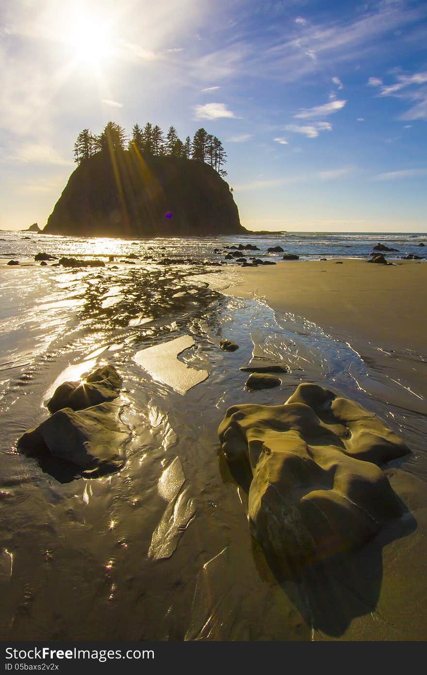 Seastack Sanctuary at Low Tide Second Beach Olympic National Park A sunny scene of the rugged sea stacks off the rocky coastline of La Push, Washington State – March 2013 . The crisp rugged detail of the bulky boulders in the foreground set the mood for this chilling seascape which captures the harsh environment of the northern Pacific coast of Washington State.