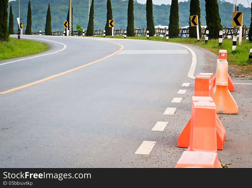 Uphill curve road with road sign