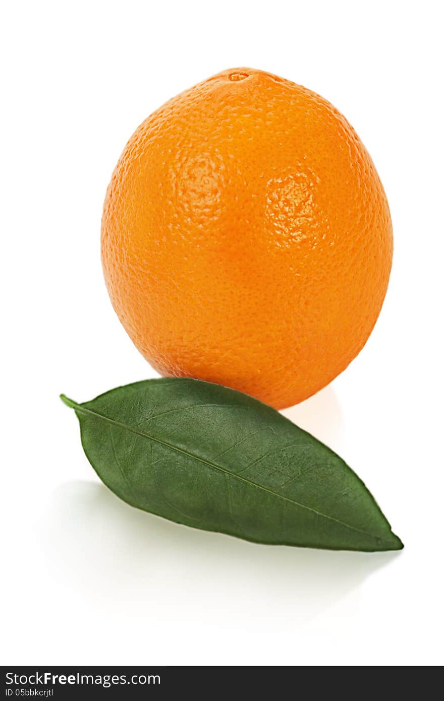 Ripe orange fruit with leaves on white background