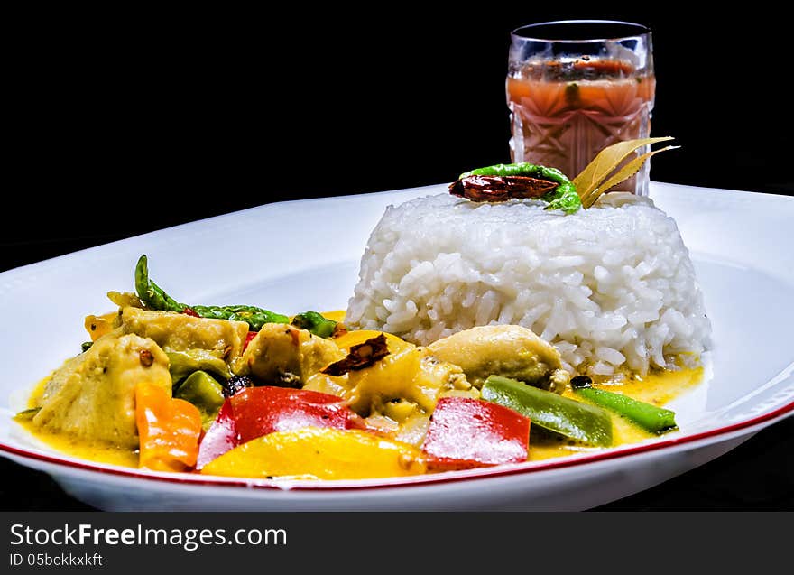 Yellow Thai chicken curry served with Jasmine rice. Yellow Thai chicken curry served with Jasmine rice.