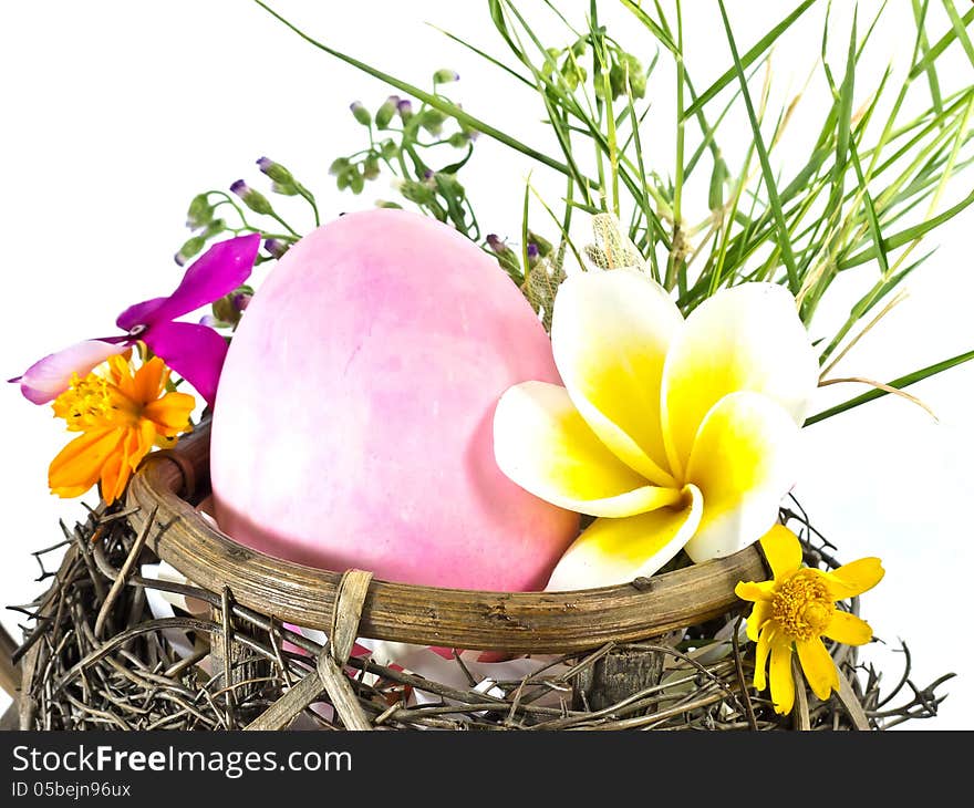 Easter egg in the basket with flowers