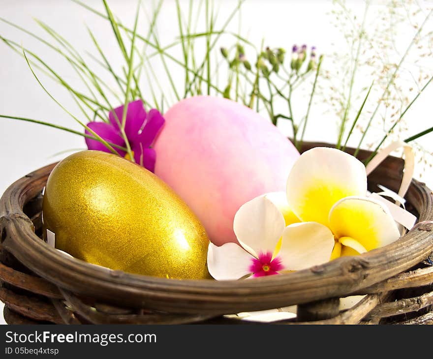 Easter egg in the basket with flowers