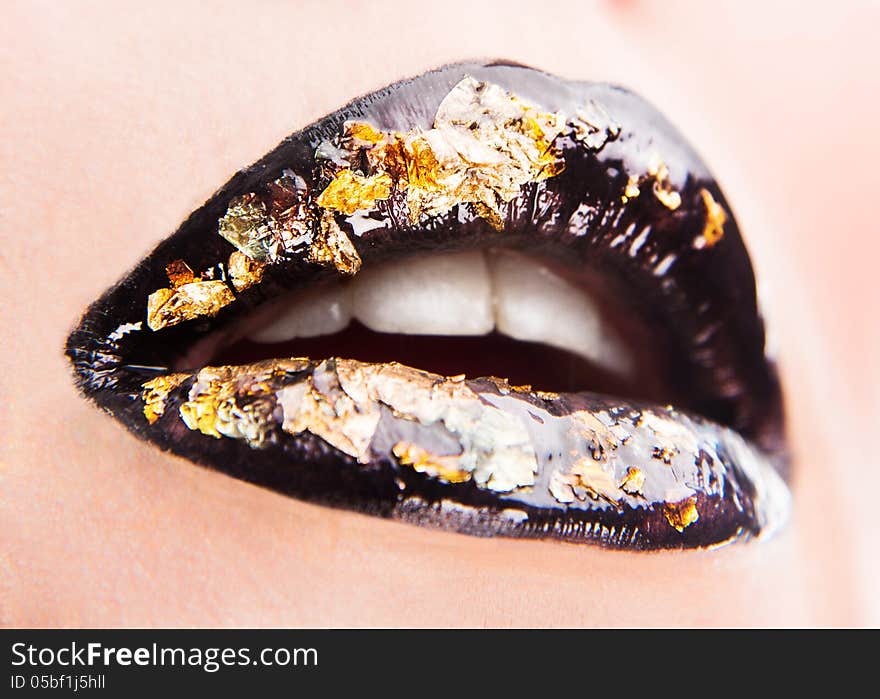 Creative glossy golden-black lips make up