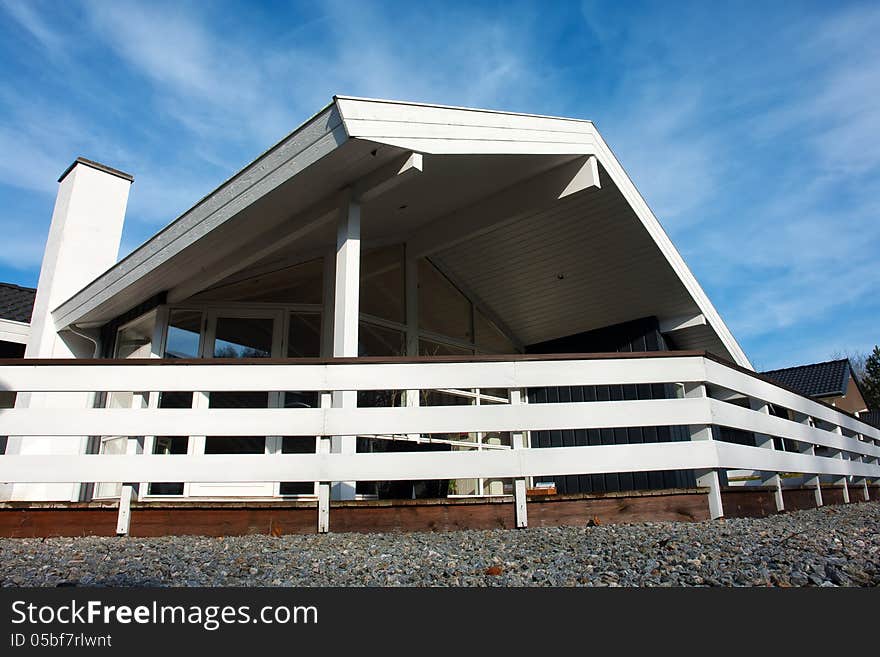 Modern style designed private wooden home summer house taken in low angle. Modern style designed private wooden home summer house taken in low angle