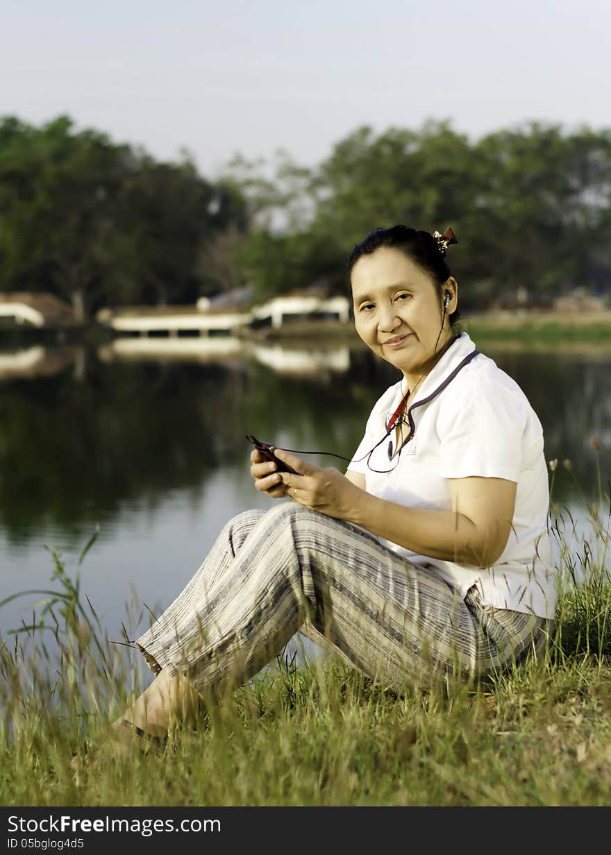 Happy Woman Listening To Music Outdoors