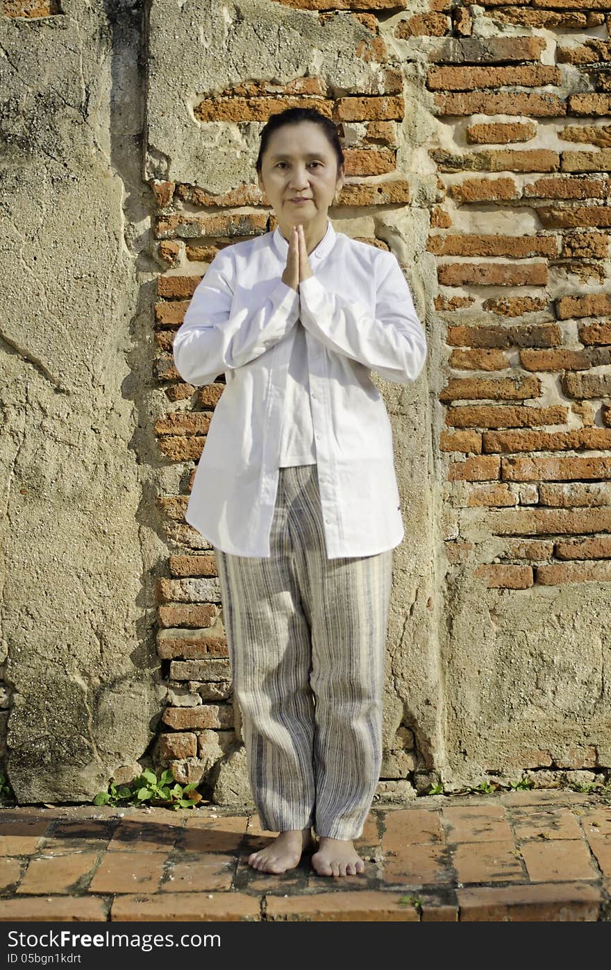 Portrait of attractive asian woman greeting with typical welcome expression sawasdee