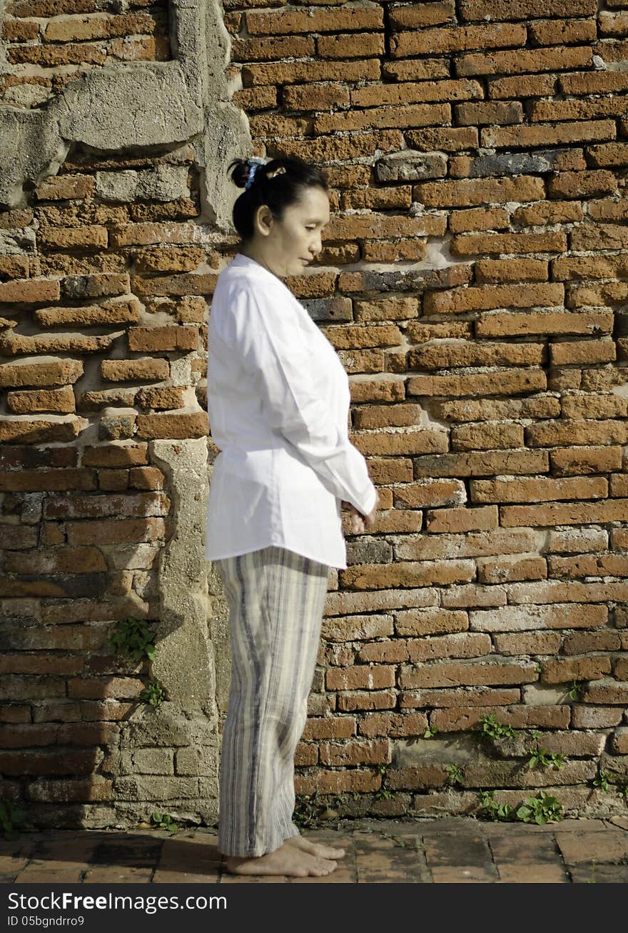 Buddhist woman standing meditating