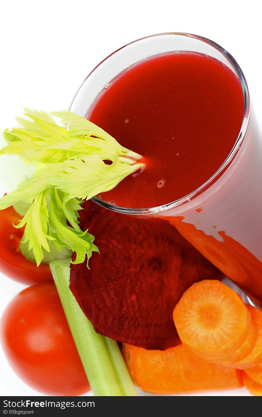 Vegetable Juice of Beet, Carrot, Celery and Tomatoes in High Glass closeup on white background