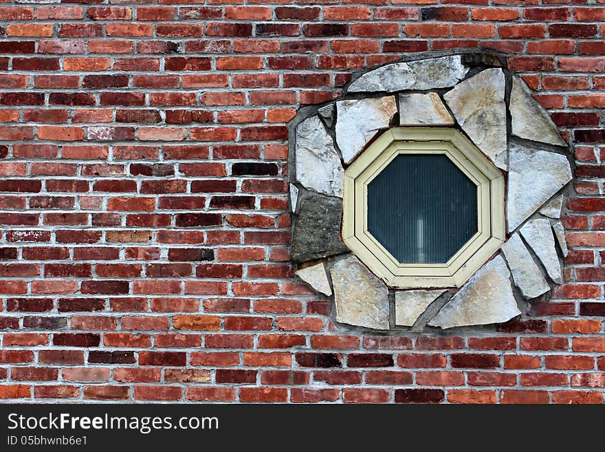 Octagon window surrounded by stone in a brick wall. Octagon window surrounded by stone in a brick wall.