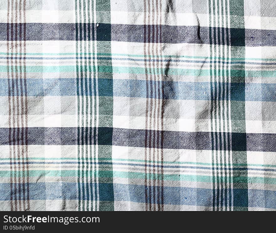 Wrinkled fabric plaid texture. Cloth background. Wrinkled fabric plaid texture. Cloth background