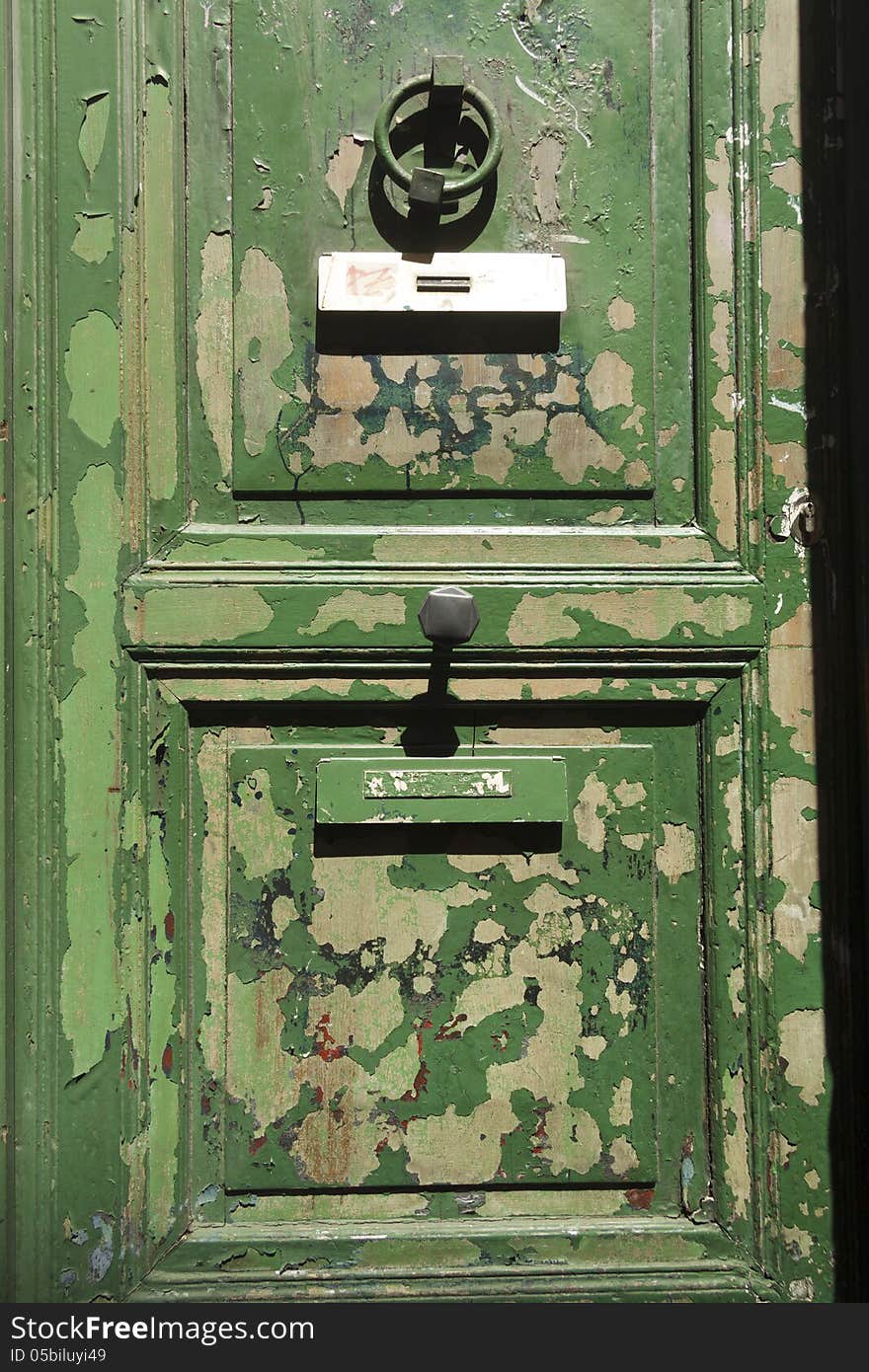 Heavily weathered green door with peeling paint. Heavily weathered green door with peeling paint