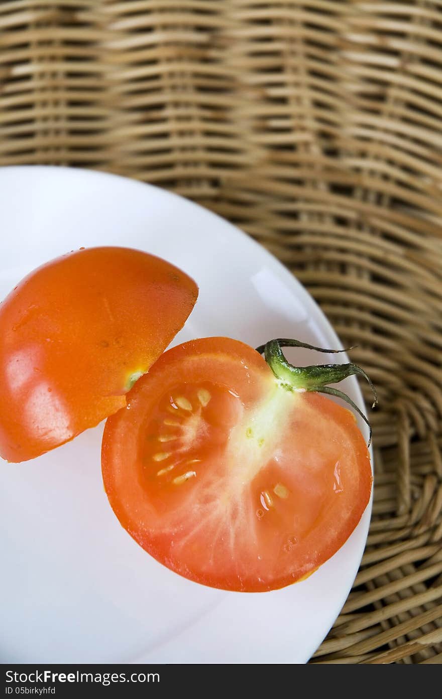 Piece of cutting fresh tomato on plate