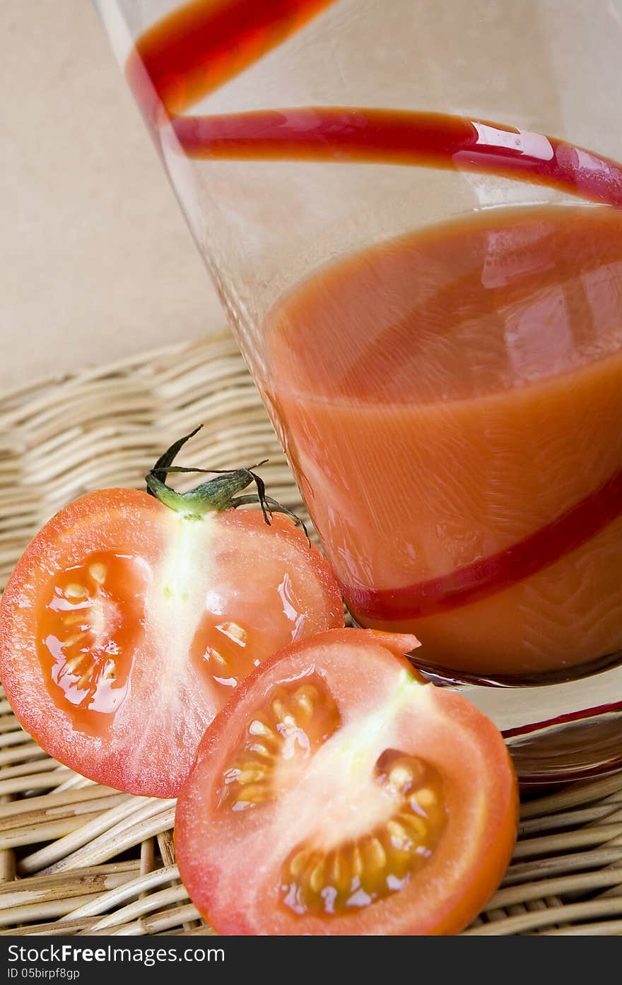 Two pieces of fresh tomato put beside tomato juice glass. Two pieces of fresh tomato put beside tomato juice glass