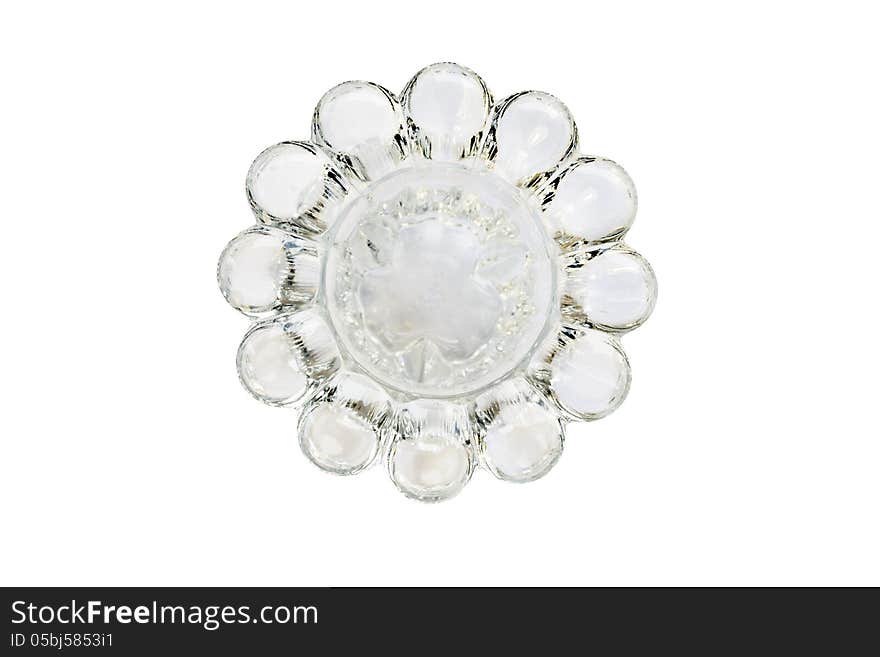 Empty glass candlestick isolated over white top view