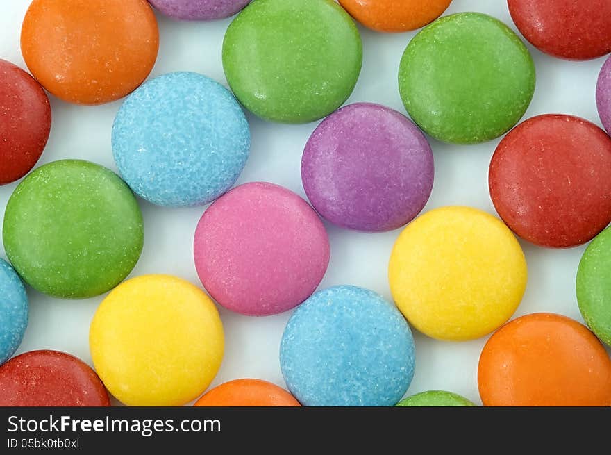 Colored chocolate candy on a white background. Colored chocolate candy on a white background