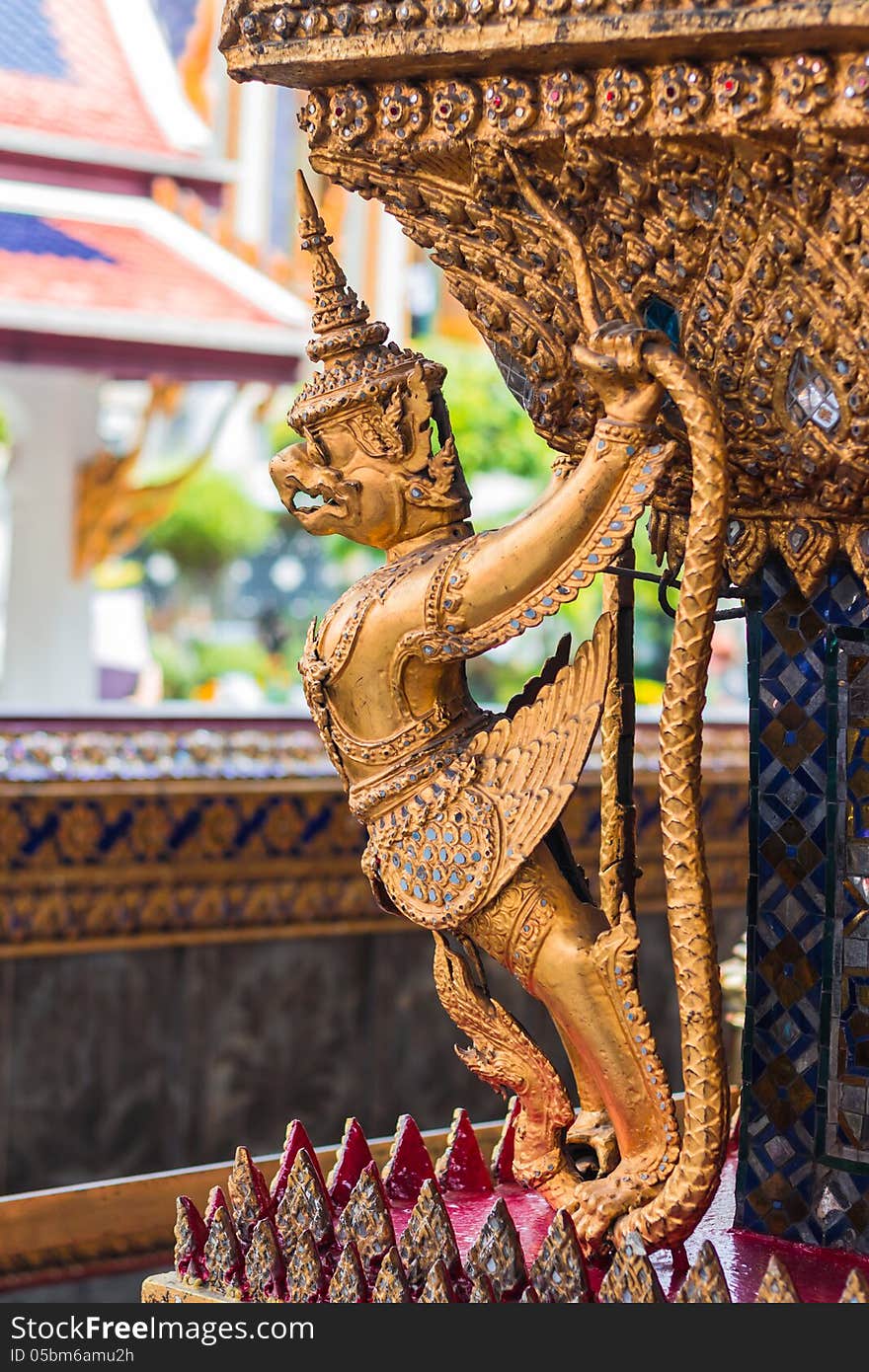 Garuda and Nagas, at the outside of the ubosot of Wat Phra Kaeo in Bangkok, Thailand. Temple of the Emerald Buddha.