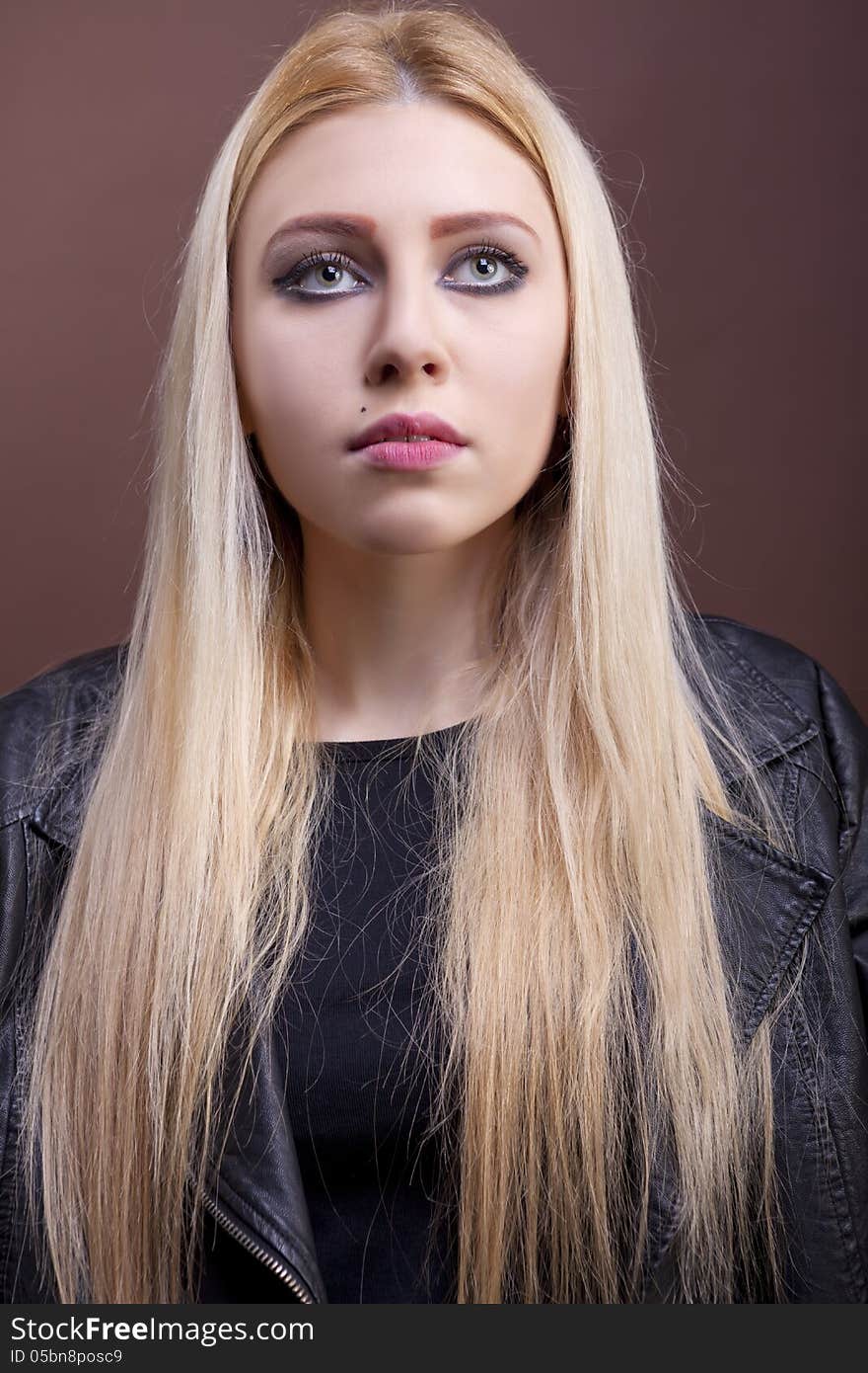 Close up portrait of a caucasian girl wearing a leather jacket studio shot