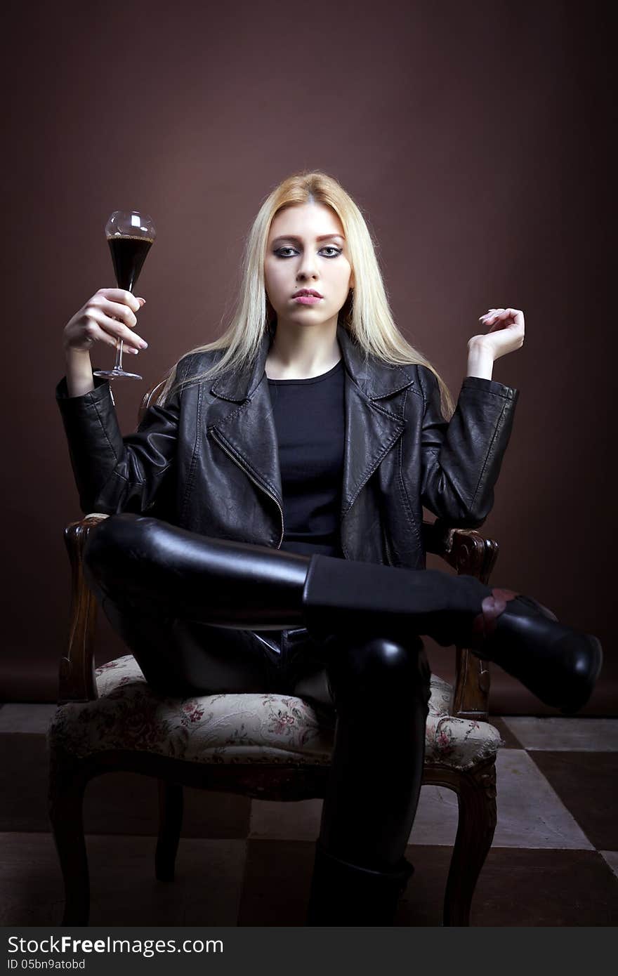 Rock Girl Holding A Glass With Dark Liquid