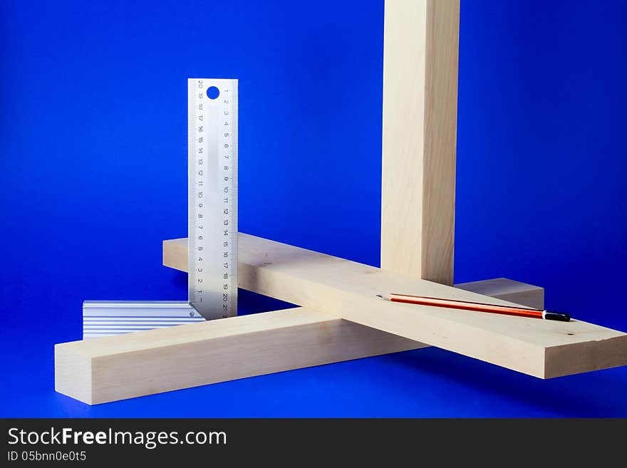 Metal setsquare and wooden bars, connected at right angles