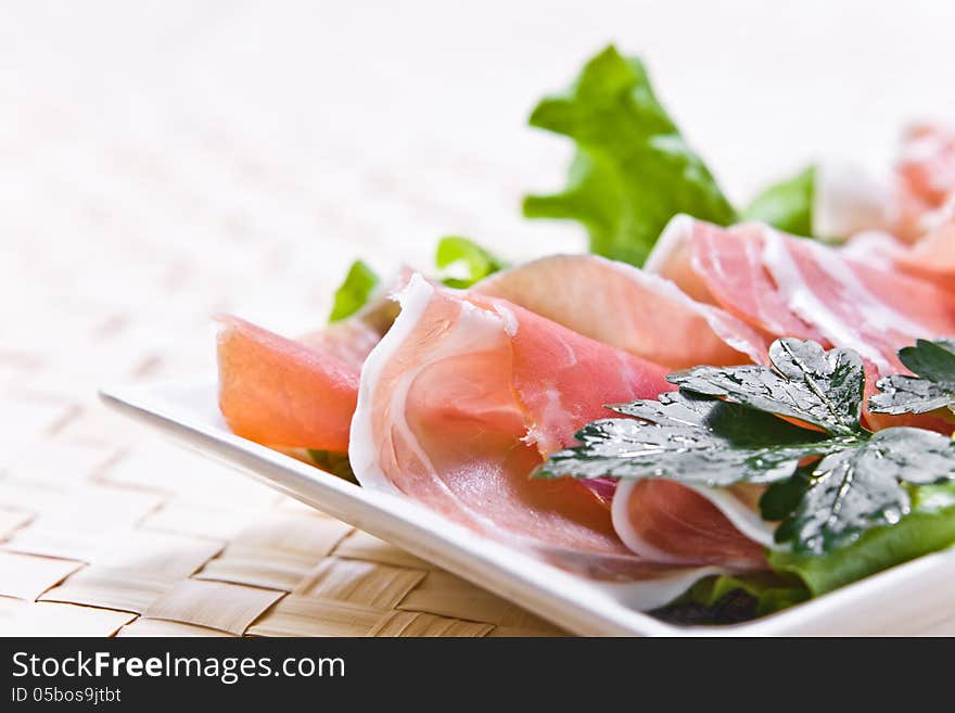 Ham and salad on a white plate