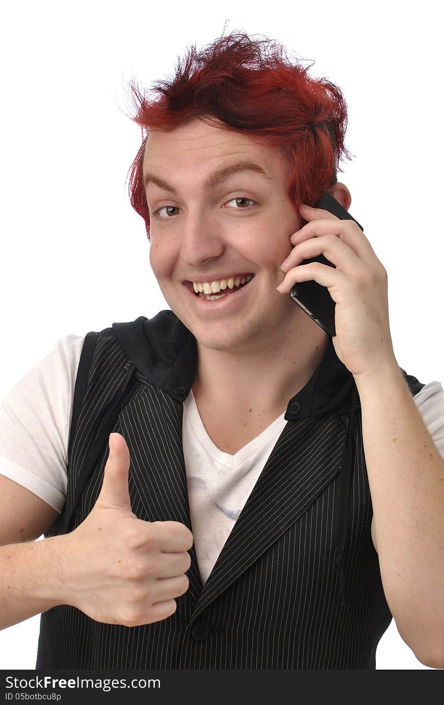 Young man gives a thumbs up as he talks on his smart phone communications device on white background. Young man gives a thumbs up as he talks on his smart phone communications device on white background