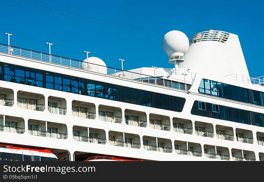 Sea travel background. Vacation on board the cruise liner - the portholes and top deck. View on luxury ocean liner. Seaside of the from the upper deck of a cruise ship.