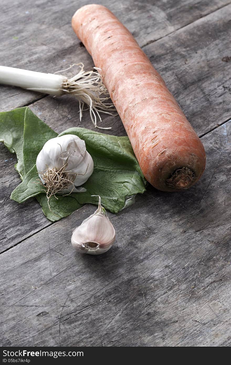 Garlic, onions and carrot on table,close up. Garlic, onions and carrot on table,close up