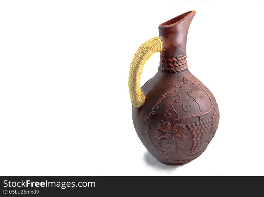 Ceramic jug for wine from red clay on a white background