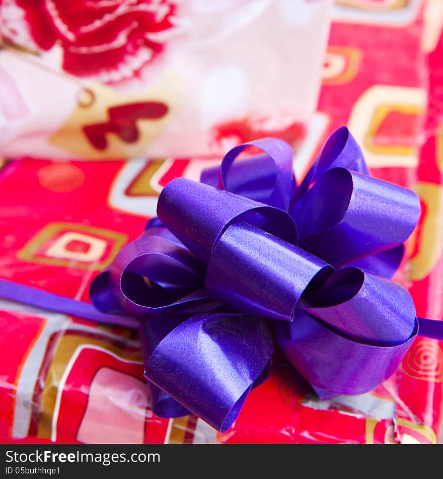 Gift paper box with blue ribbon bow