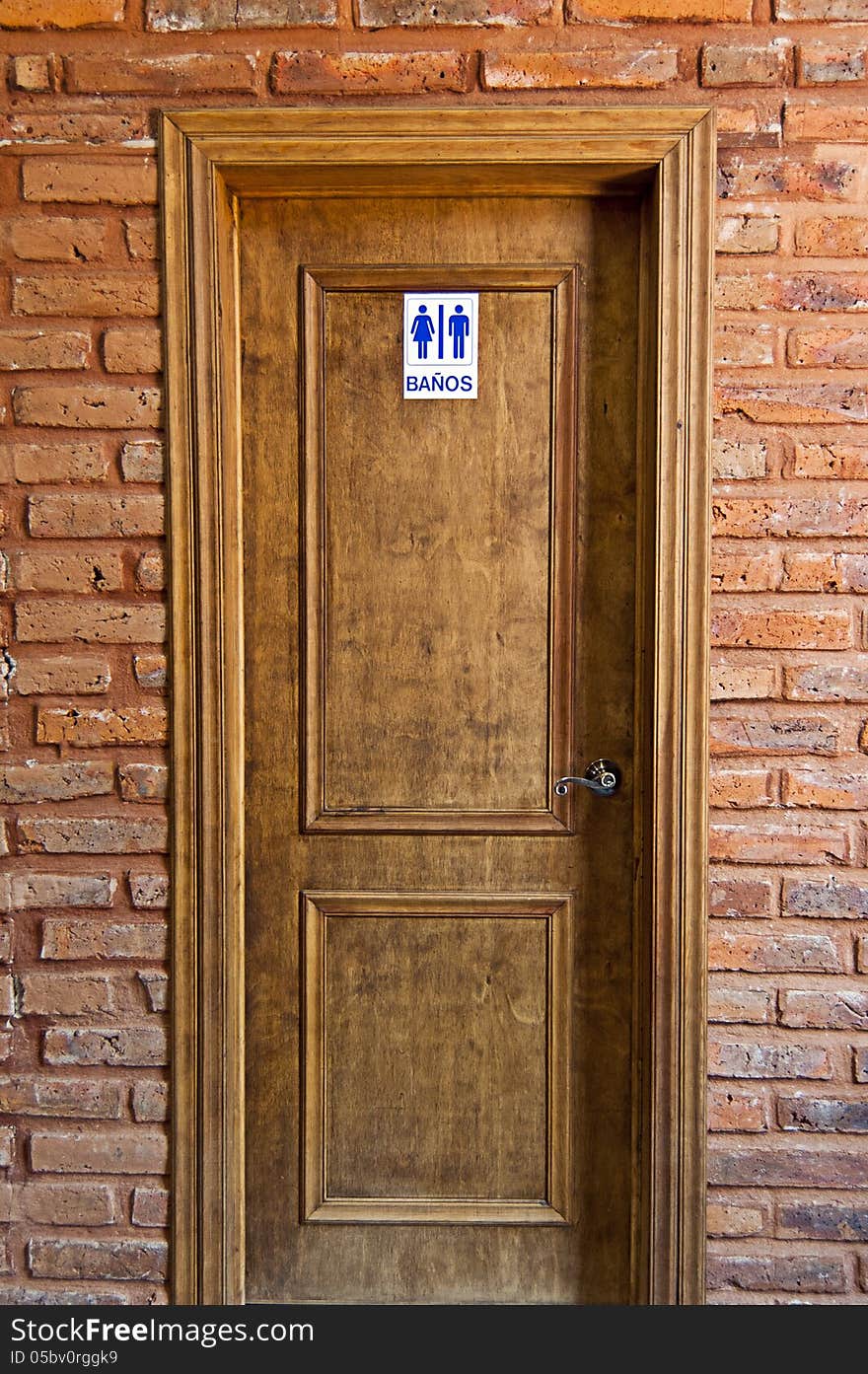 Entry to bathroom and wooden door frame and brick