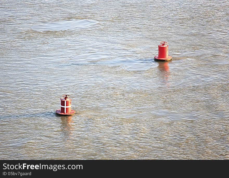 Red buoys on river.