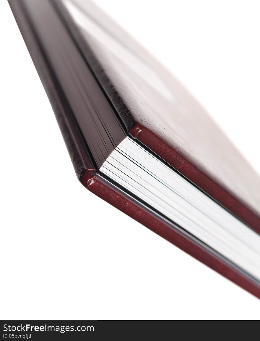 Side view of book with leatherette cover on white backgrounds