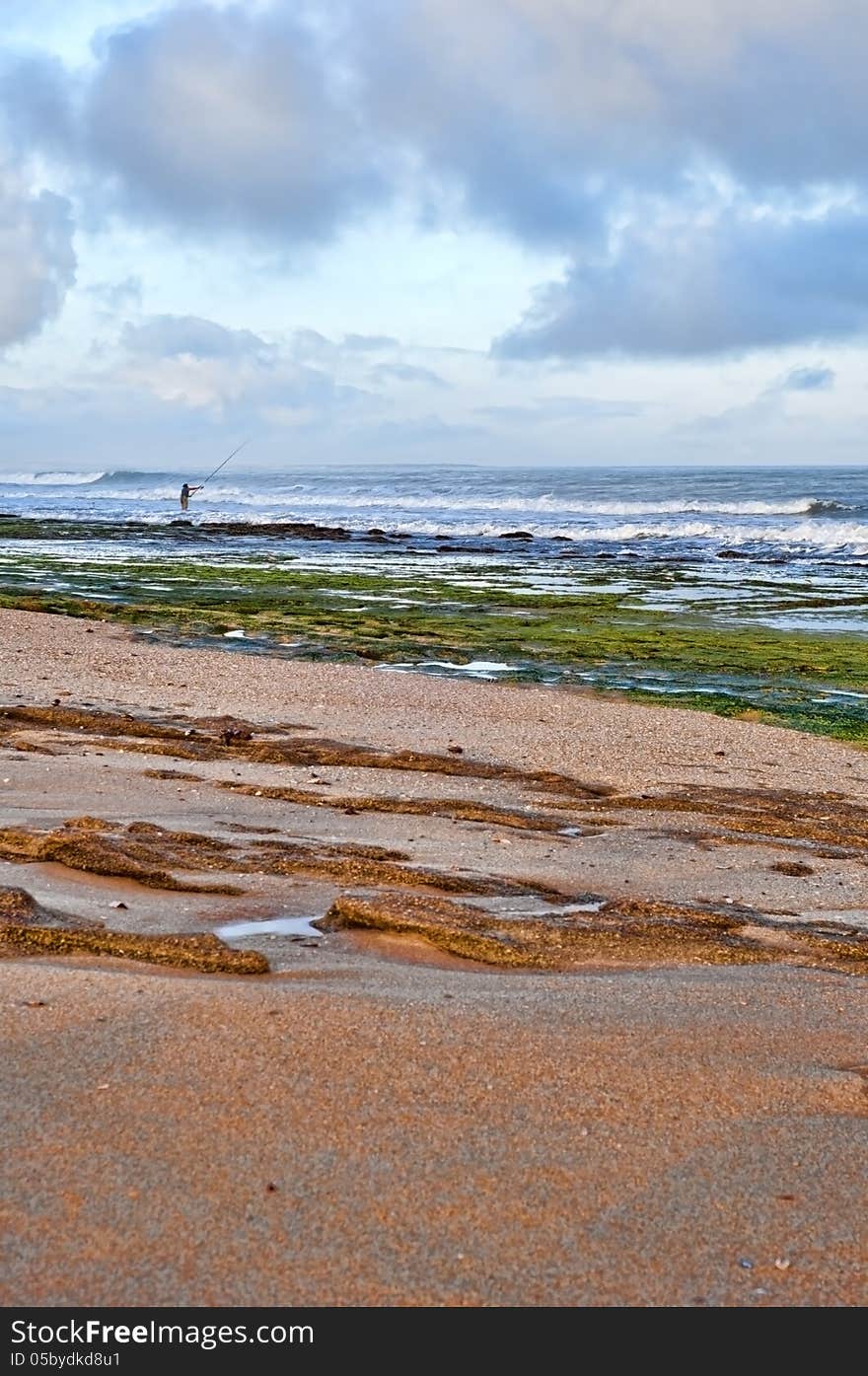 Fisherman  With Fishing Rod On The Beach