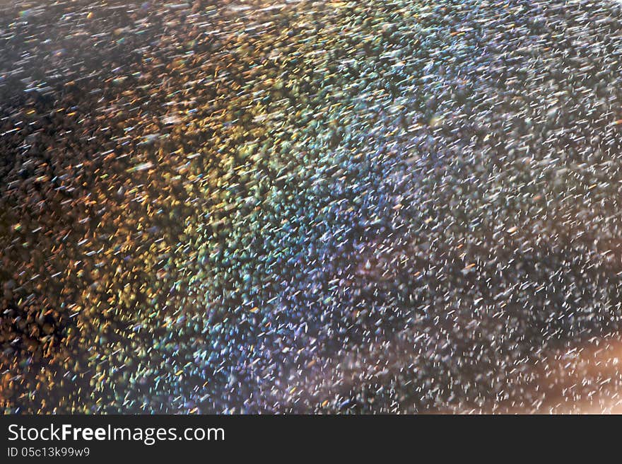 Abstract of airborne water droplets with lots of depth of field (DOF) and rainbow coloring. Abstract of airborne water droplets with lots of depth of field (DOF) and rainbow coloring.