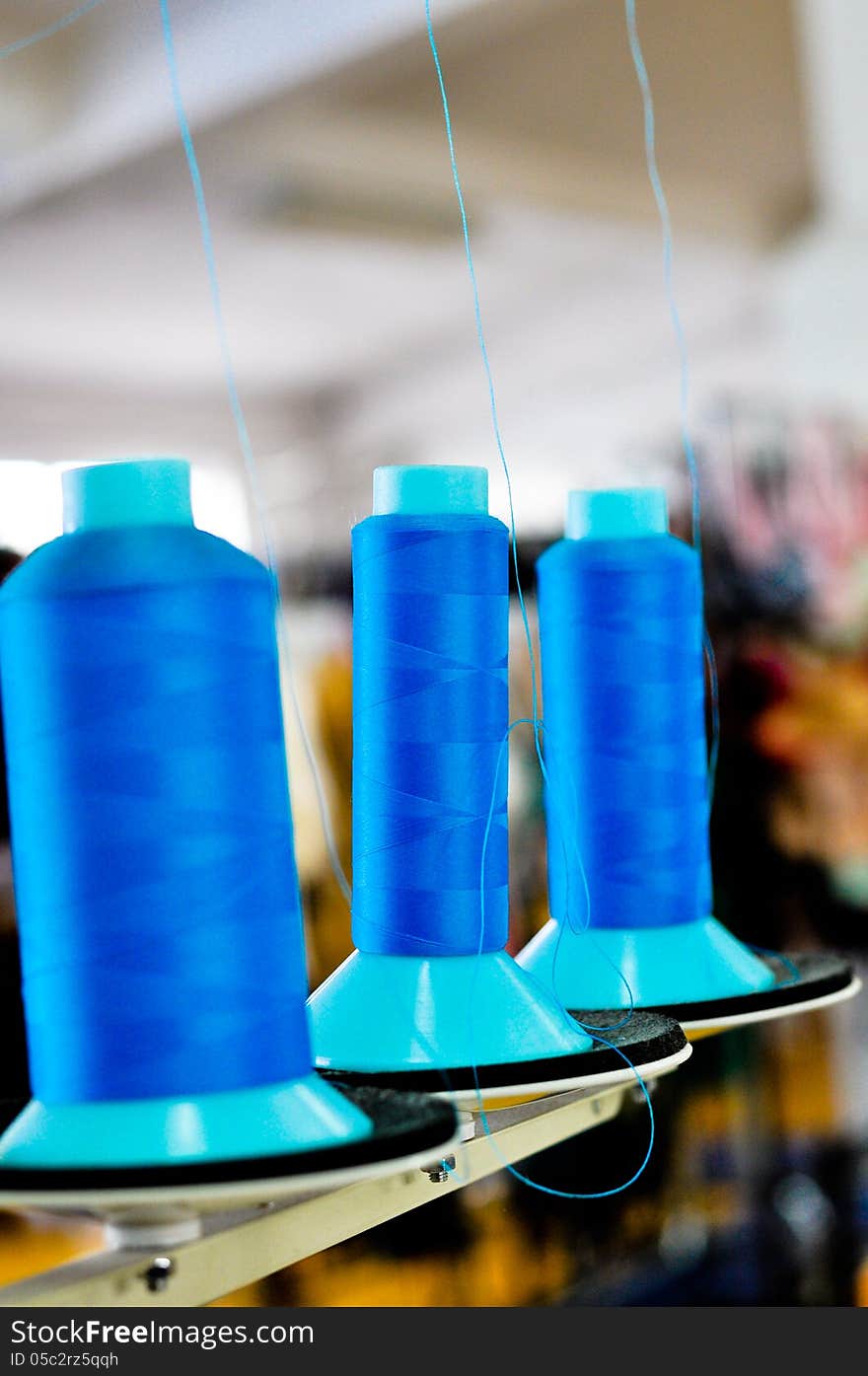 Blue spools in a clothing factory