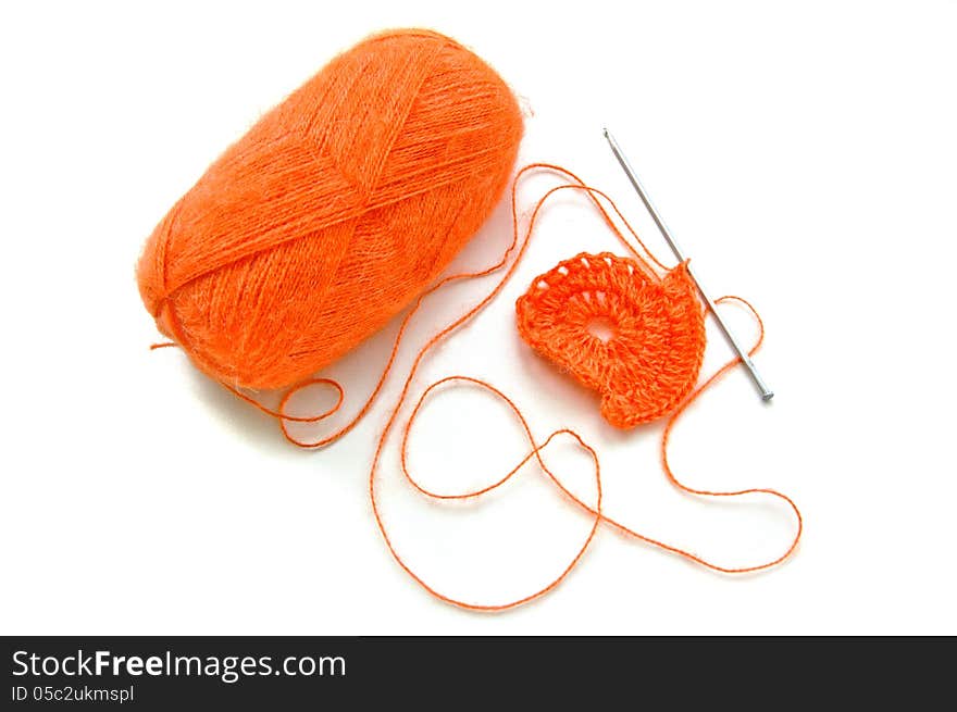 Crochet hook and a ball of yarn on white background. Crochet hook and a ball of yarn on white background.