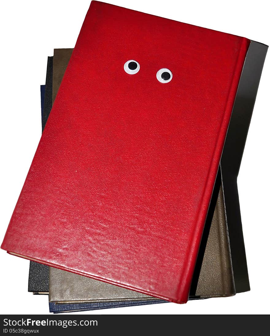 The red book is on other books.